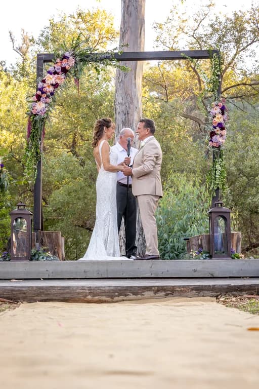 The ceremony on a wooden platform under the oaks