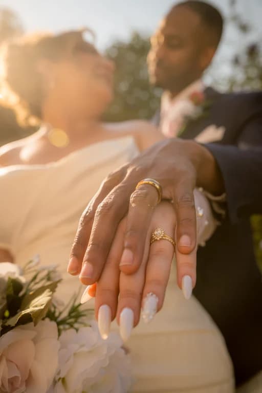 Lola's hand with her rings over Brandon's