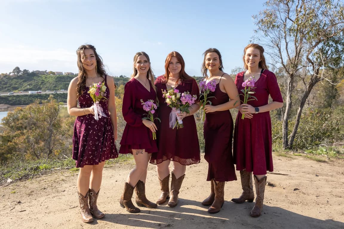 Bridesmaids in burgundy and cowboy boots