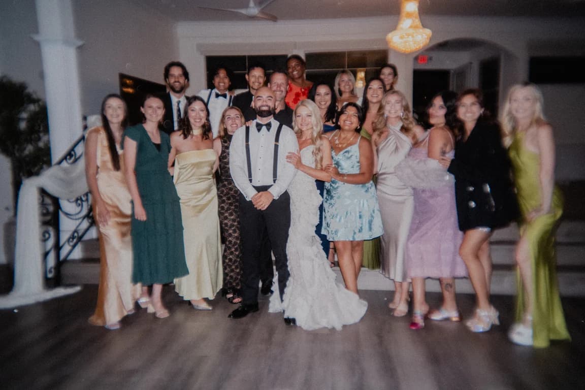 Jovin + Jordyn with their guests under the chandelier