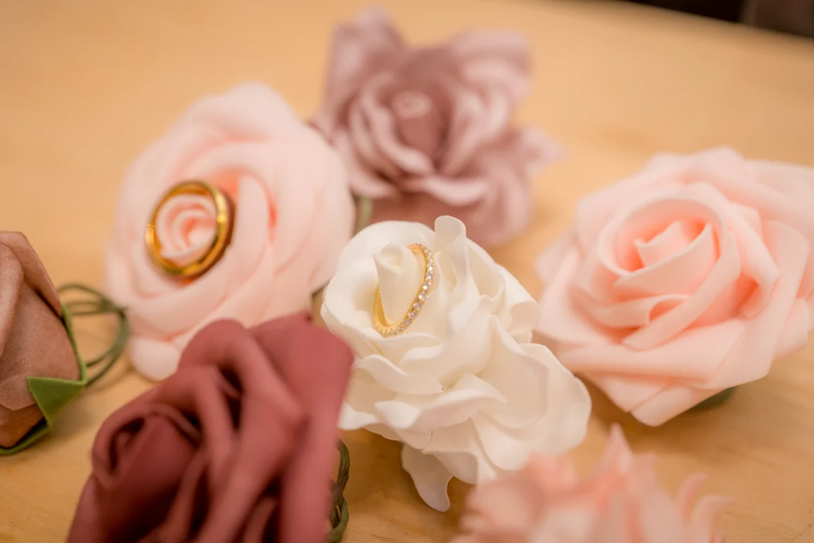Brandon + Lola's wedding bands resting on roses