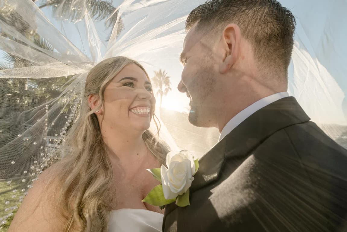 Cecelia smiling at Joseph, her veil lifting in the breeze