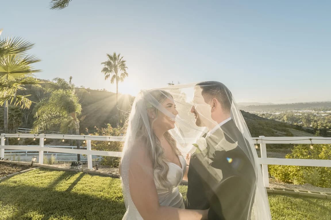 Joseph + Cecelia under her veil, backlit by the low sun