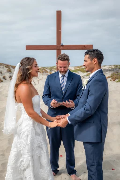 Niko + Kiara holding hands at the wooden cross