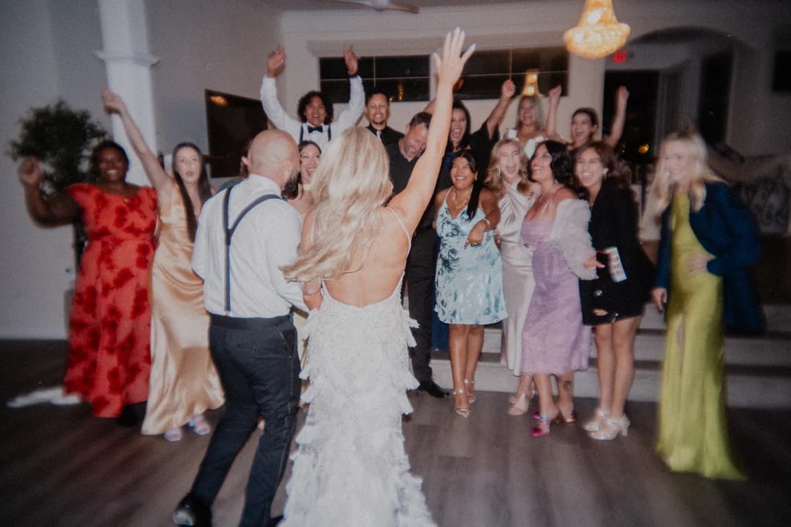 Jordyn dancing with her arm raised, guests around her