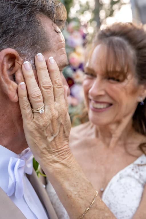 Joy's hand with her ring on Randy's cheek