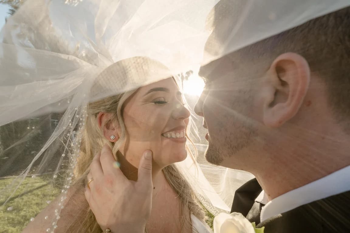 Cecelia laughing under her veil with Joseph