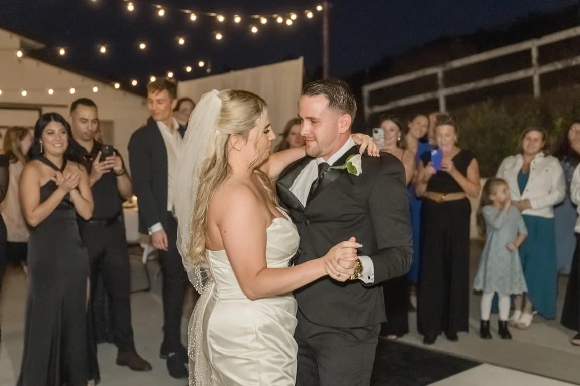 Joseph + Cecelia's first dance under string lights