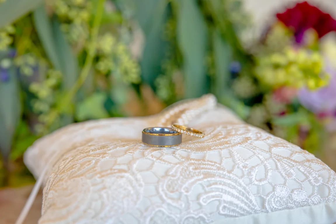 Randy + Joy's wedding bands resting on lace