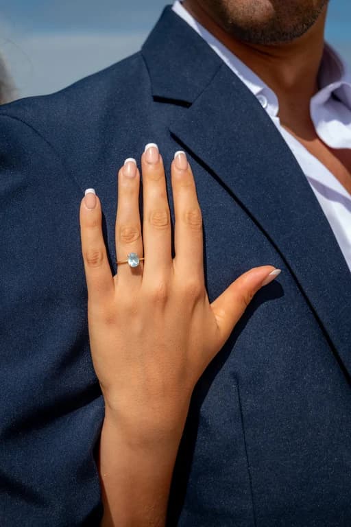 Kiara's hand with her ring on Niko's lapel