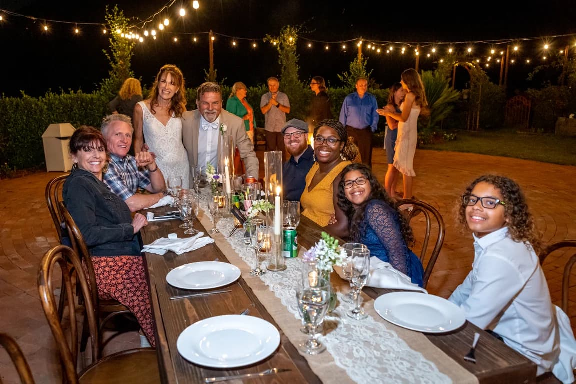 Guests at long tables under string lights