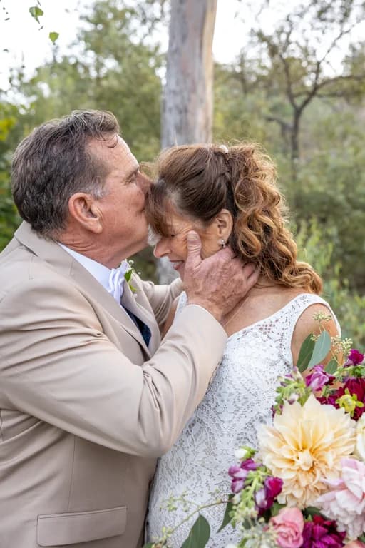 Randy kissing Joy's forehead