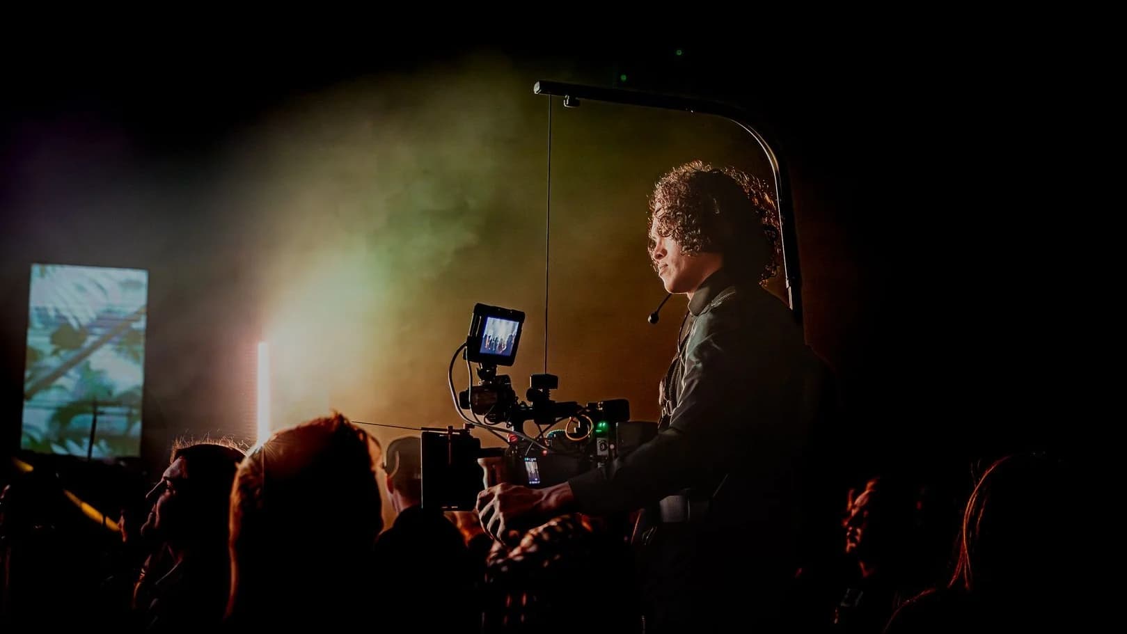 Paul Dal behind a cinema camera rig at a live event, crowd in the foreground