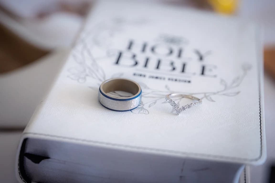 Wedding bands resting on a Bible