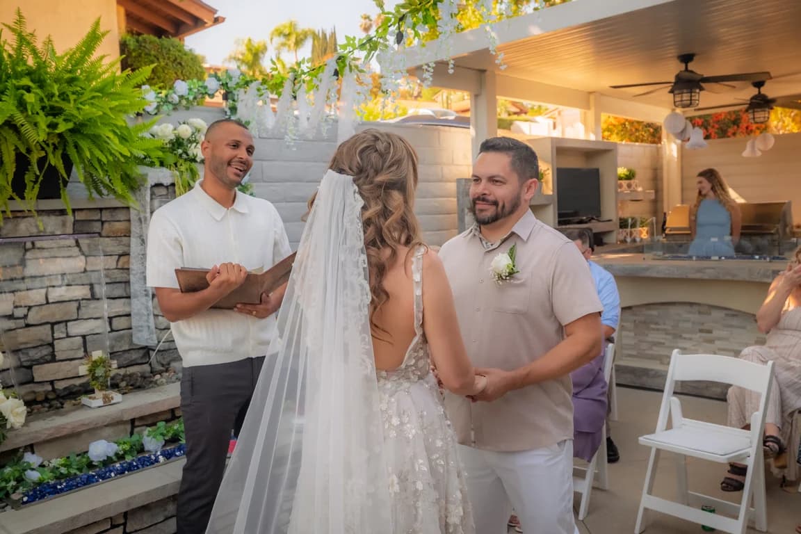 Katy + Ryan facing each other at the ceremony
