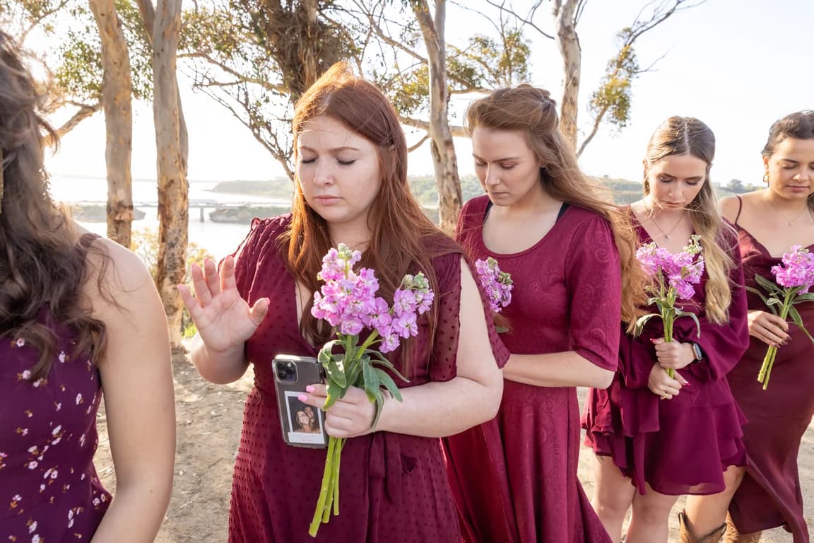 Bridesmaids with hands raised in prayer