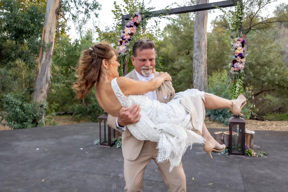 Randy lifting Joy in his arms