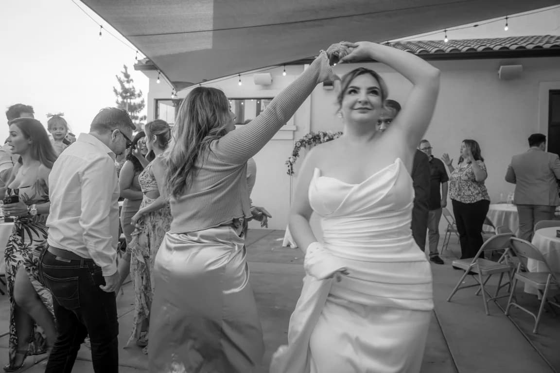Lola dancing at the reception, in black and white