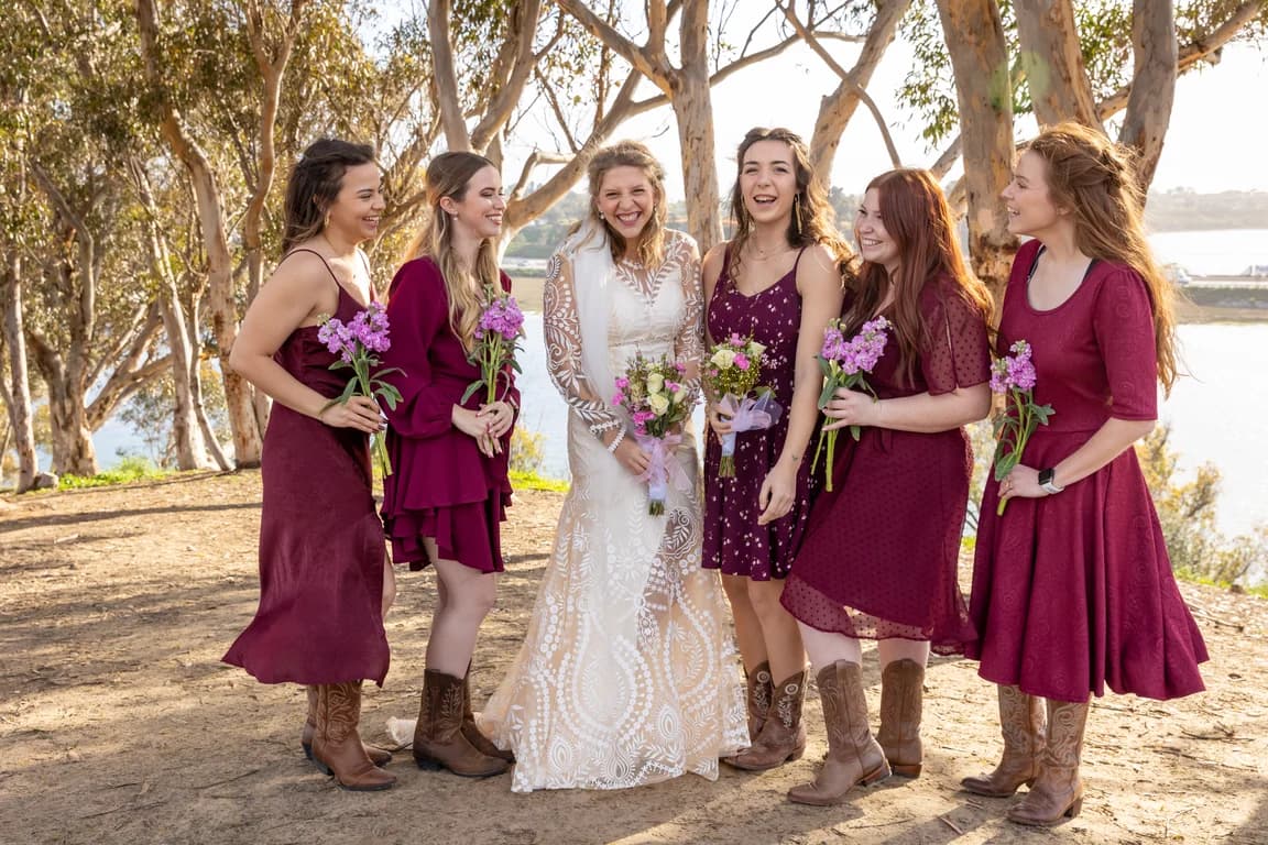 Bridesmaids in burgundy cheering with Michaela