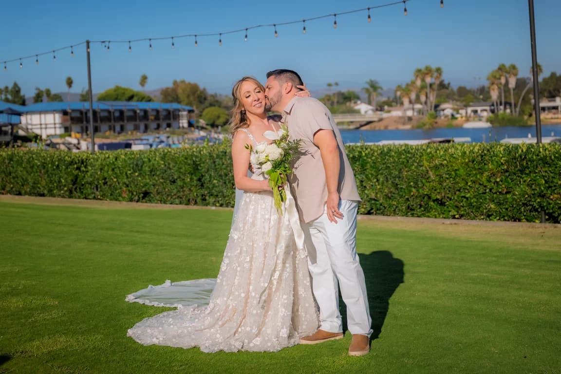 Katy + Ryan laughing, her bouquet of white flowers