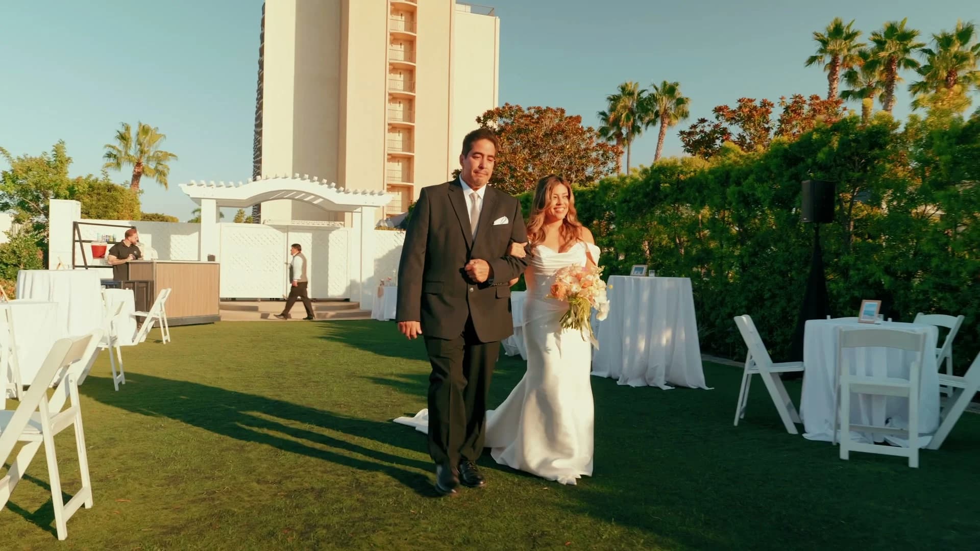 Angela coming up the lawn toward the ceremony