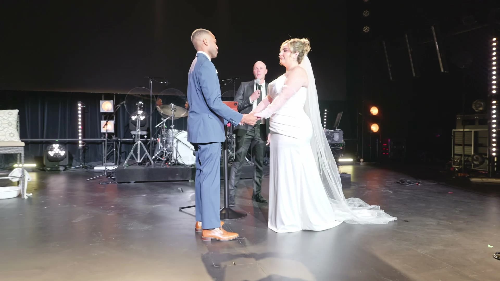 Brandon + Lola holding hands on the stage at Jesus Culture, Poway
