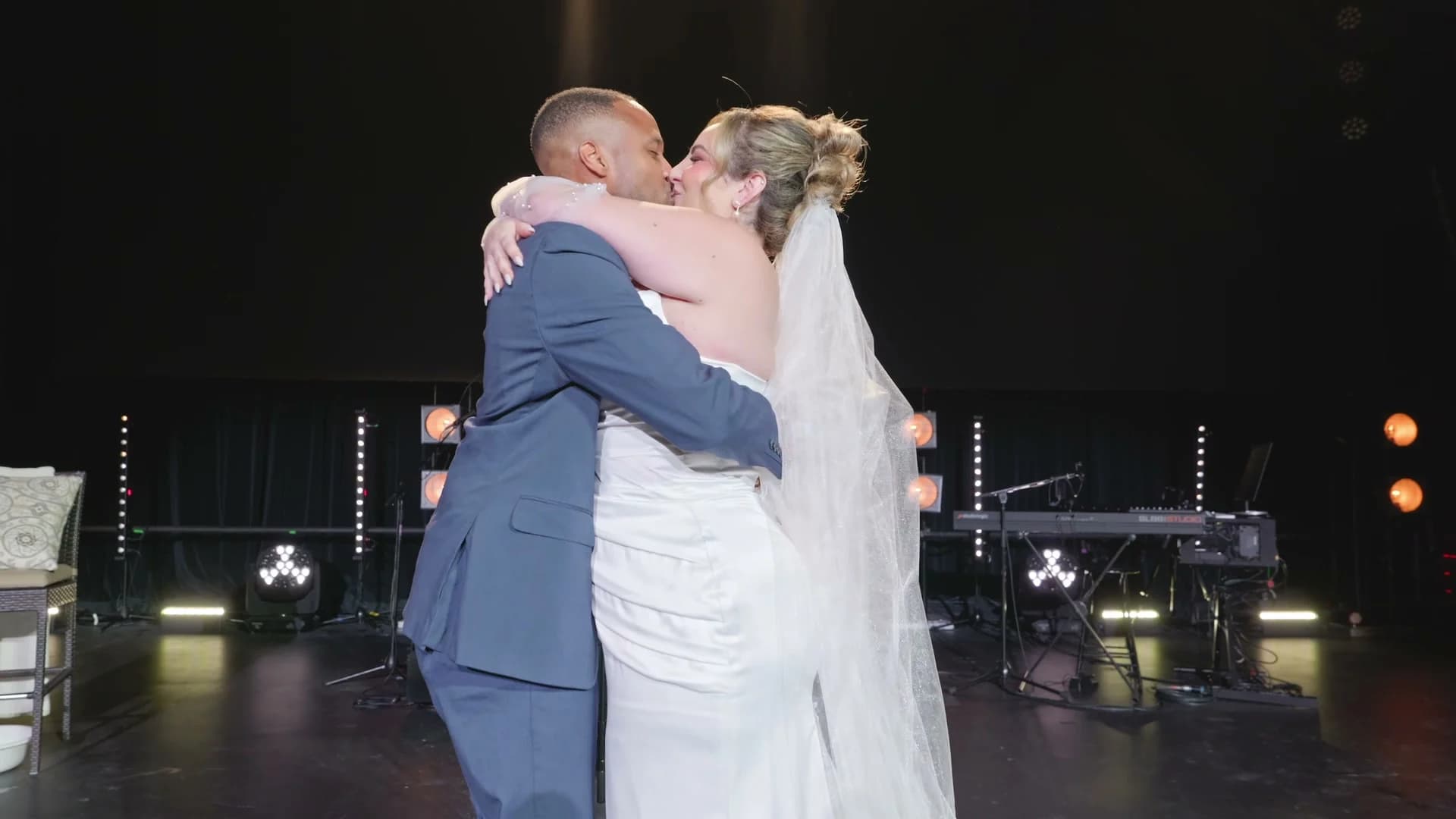 Brandon + Lola embracing on stage