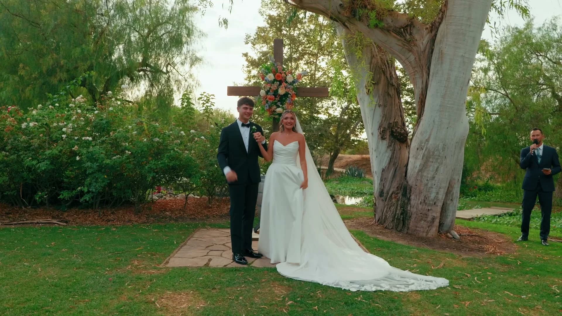The ceremony beside the wooden cross and the old sycamore