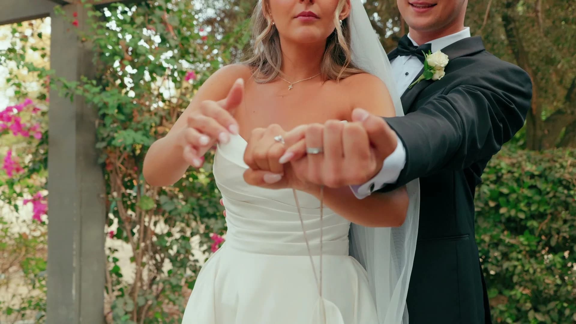 Denis + Cadin holding out their hands to show their rings