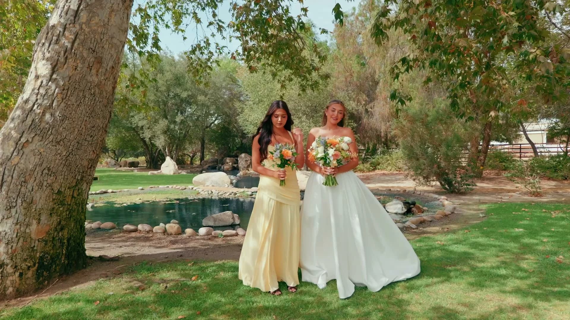Cadin with a bridesmaid in yellow by the pond