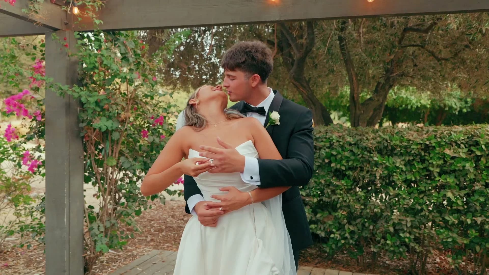 Denis + Cadin kissing under the pergola