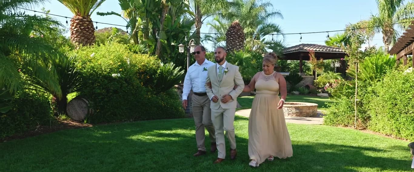 Ivan walking down the aisle with family on either side