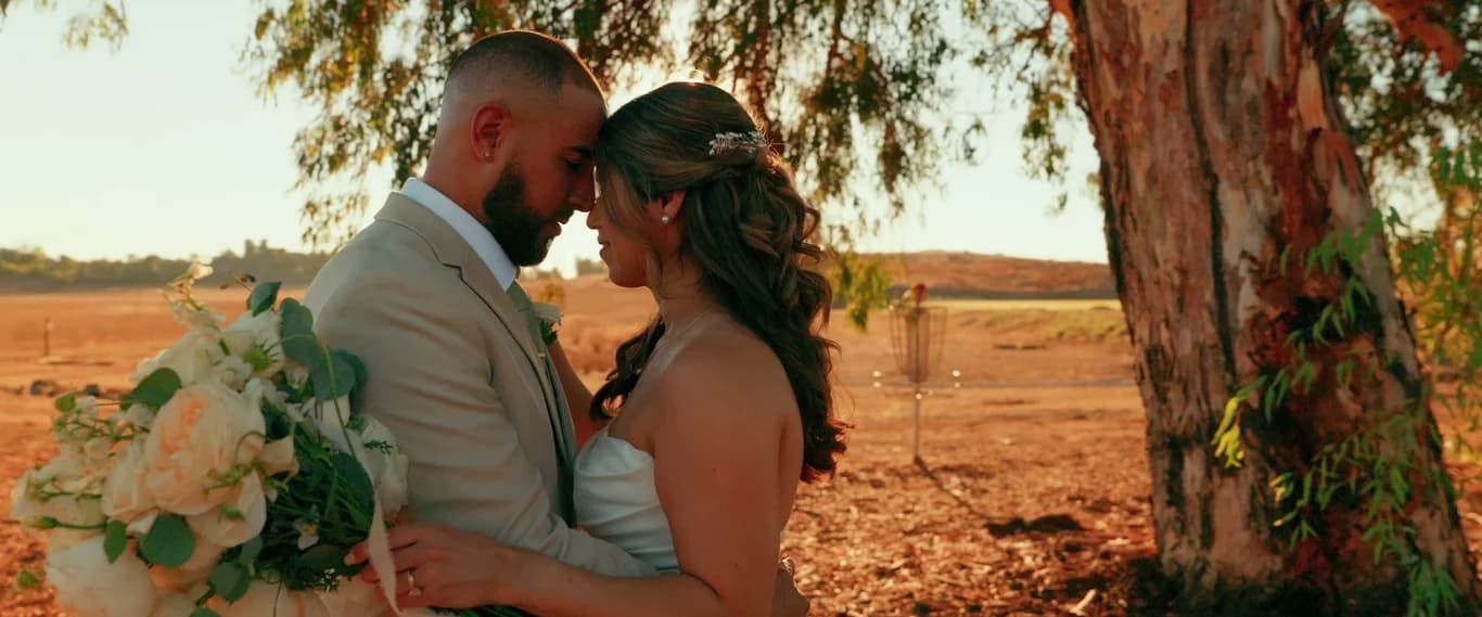 Ivan + Yesenia foreheads together in the field