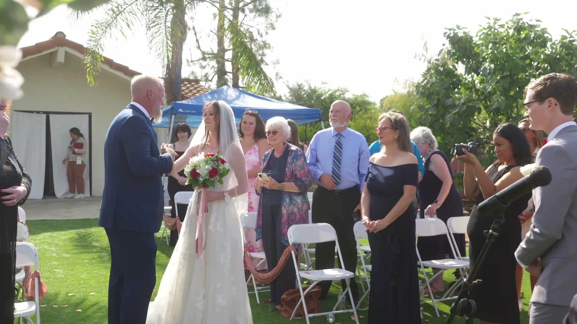 Lizzy walking down the aisle as guests stand on either side