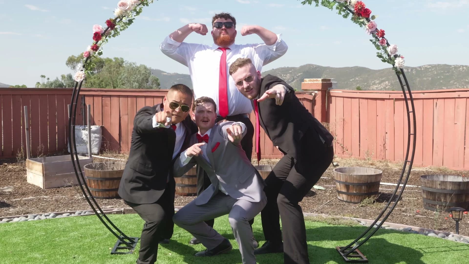 Groomsmen striking a pose under the arch