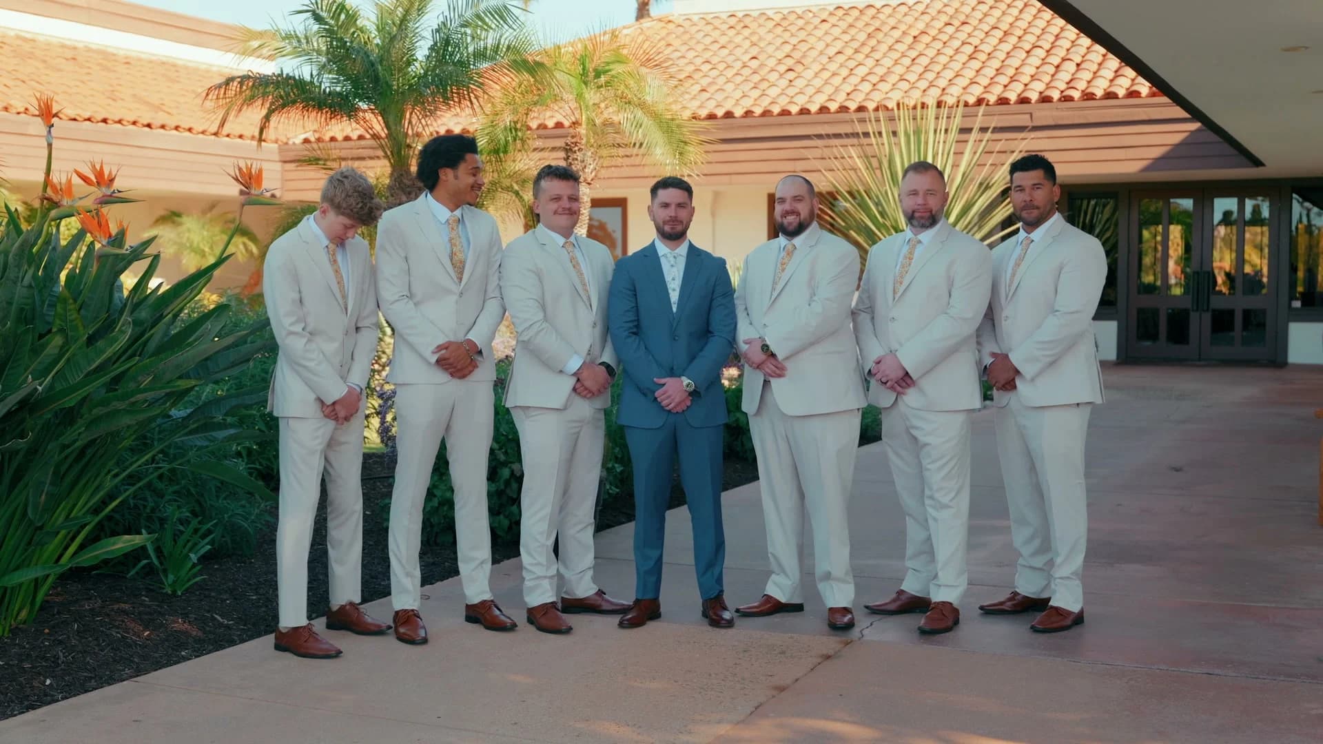 Brett in blue with his groomsmen in cream suits