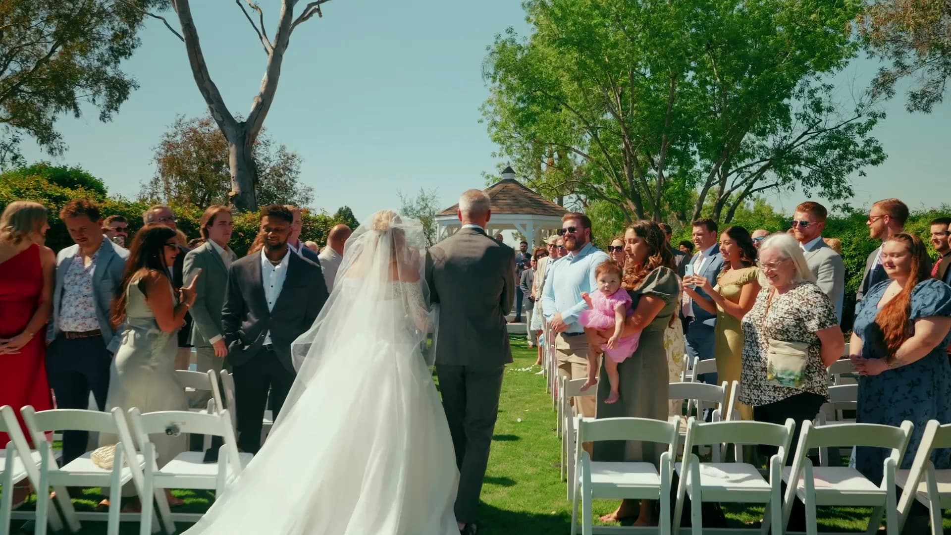 Kat walking down the aisle as guests stand