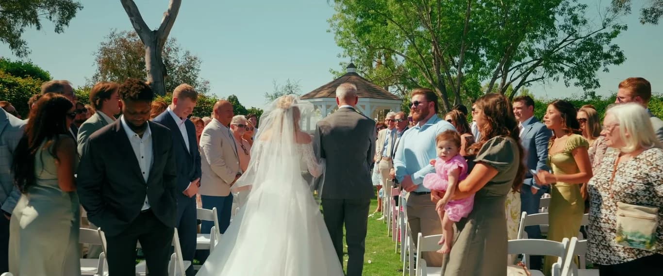 Kat at the end of the aisle, guests on either side
