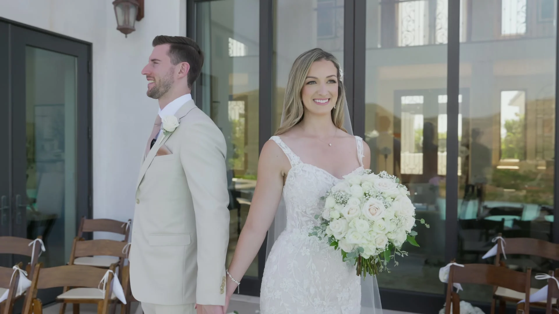 Patrick + Megan standing together by the tall windows