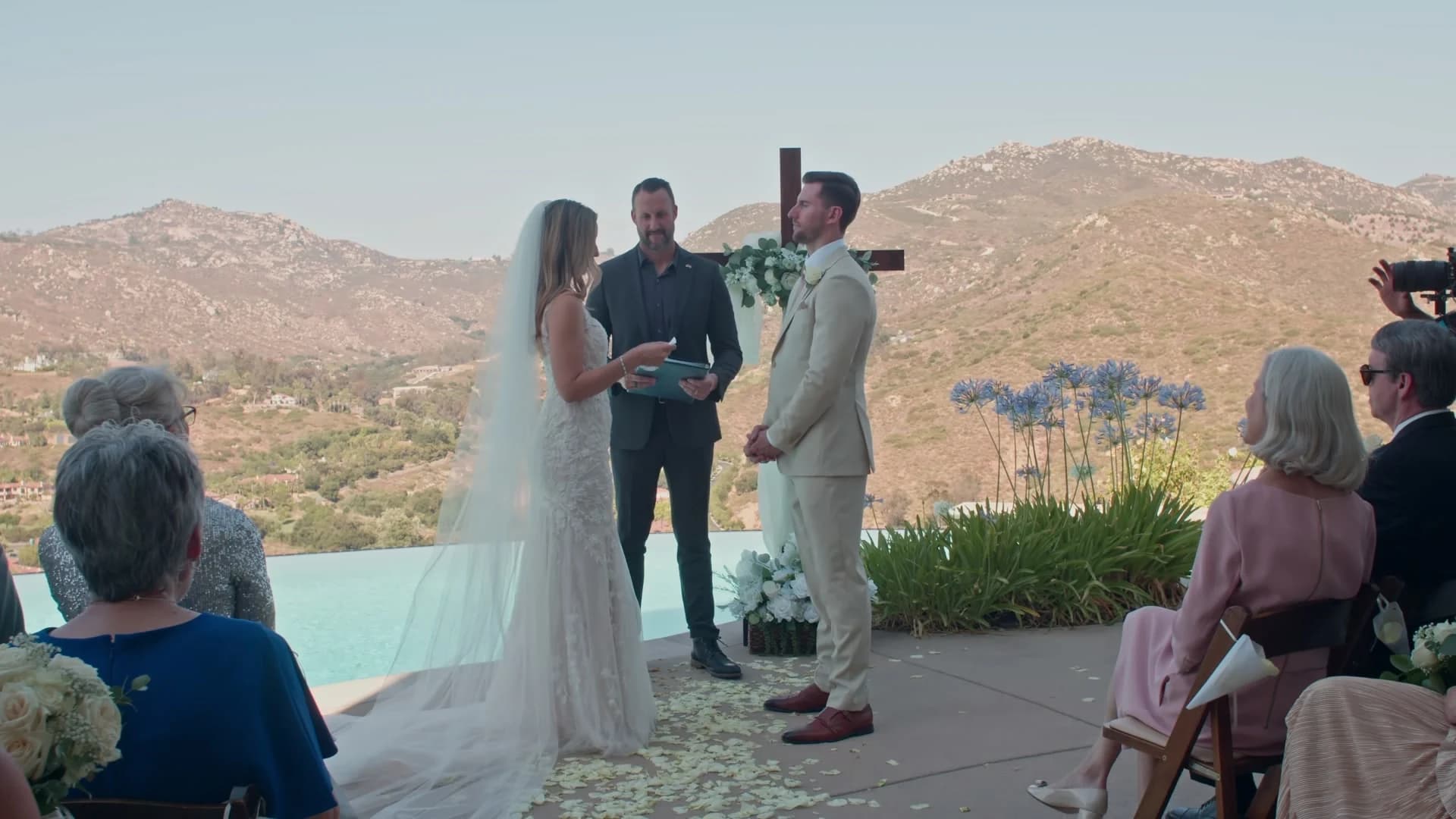 The ceremony by the pool, the mountains behind it