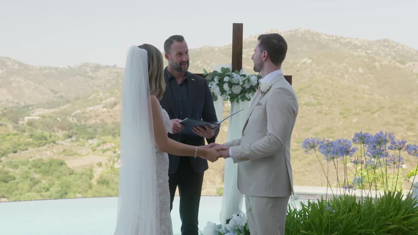 Patrick + Megan's ceremony by the pool in front of a wooden cross, Escondido
