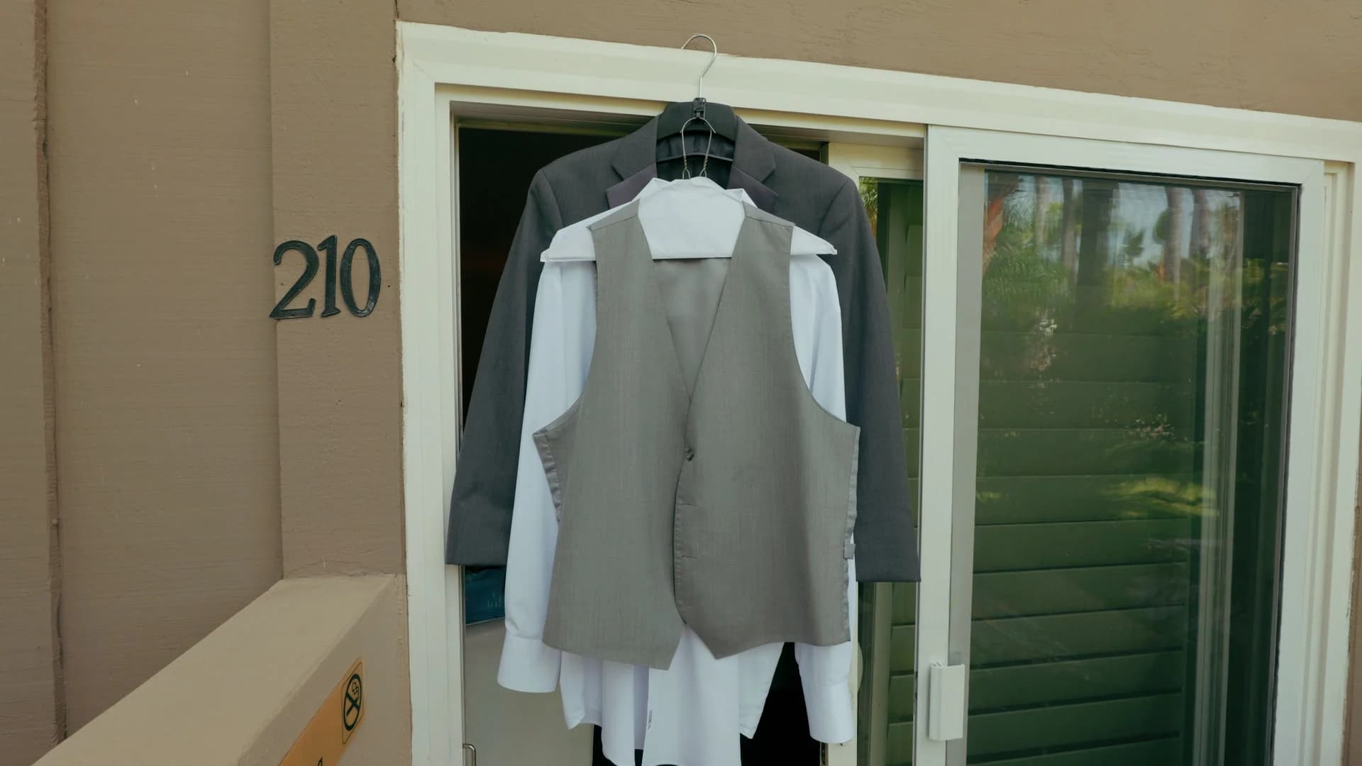 Suits hanging on a door before the ceremony