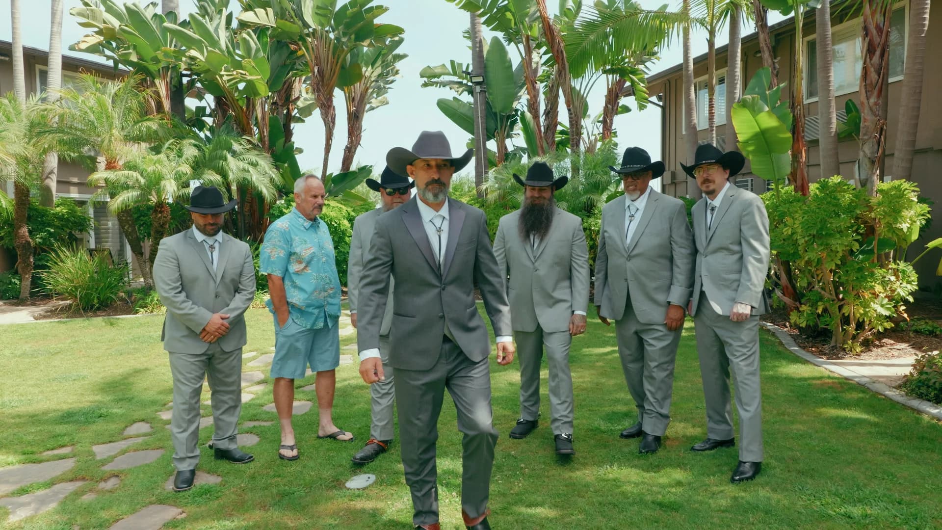 Kris and his groomsmen in cowboy hats in the courtyard