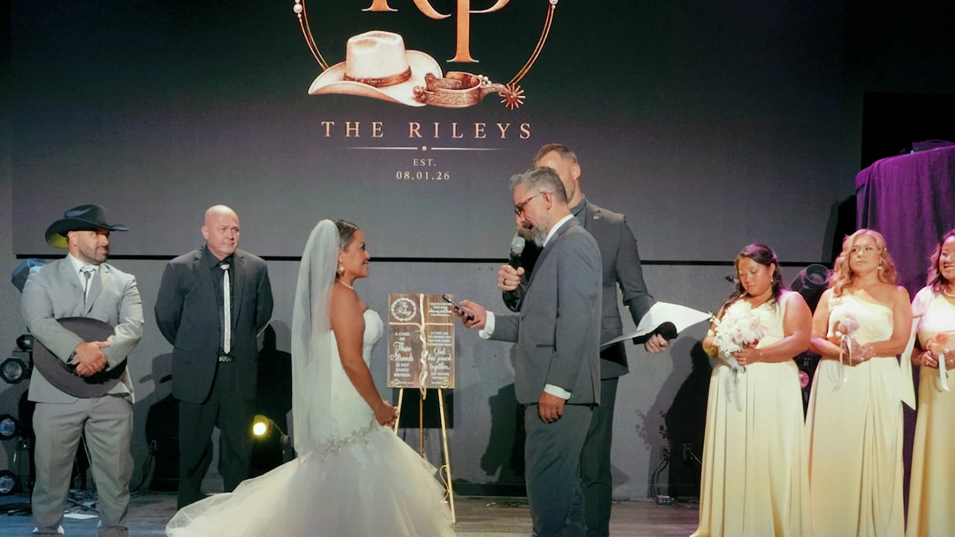 Kris + Pearl's ceremony on the stage at Awaken Church, their monogram on the screen