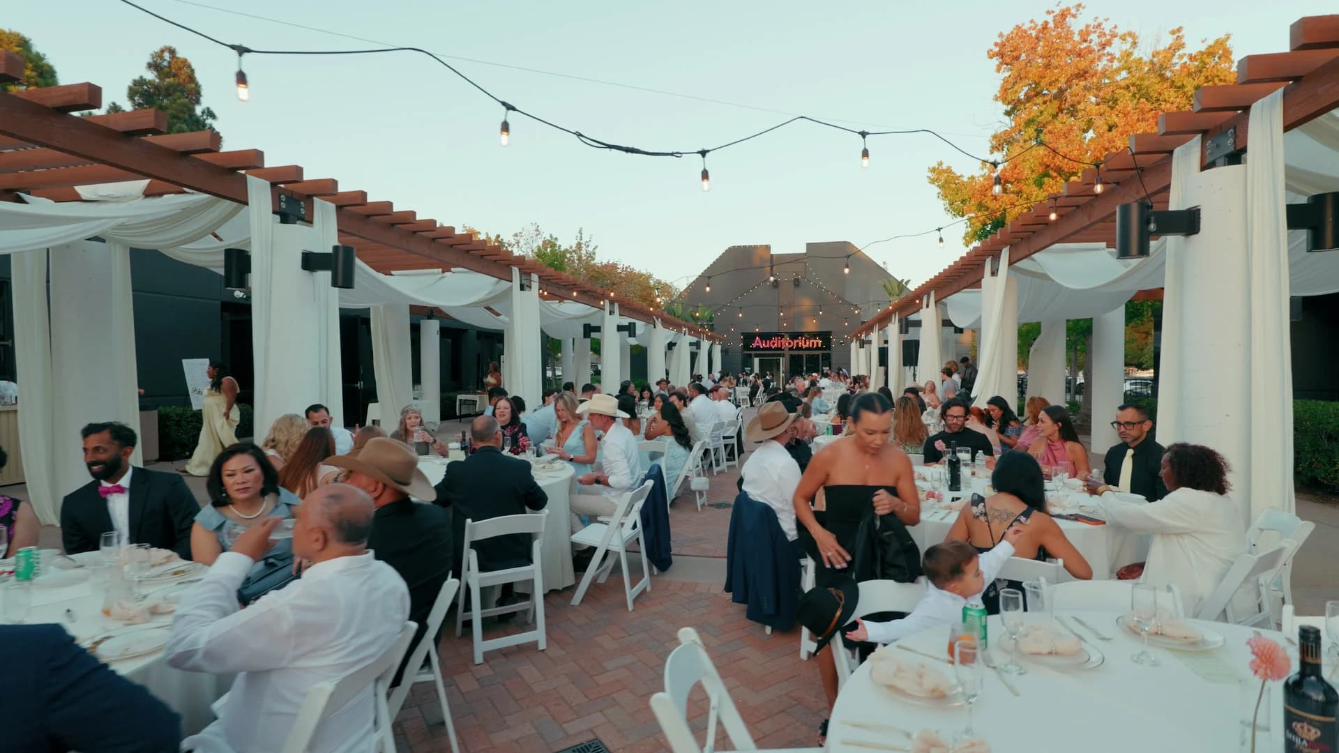 The reception outside under the white pergola