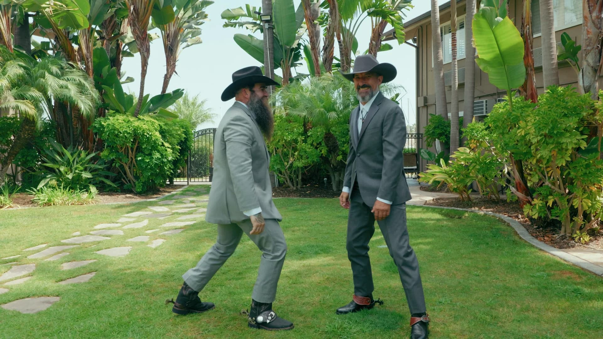 Groomsmen in cowboy hats crossing the lawn