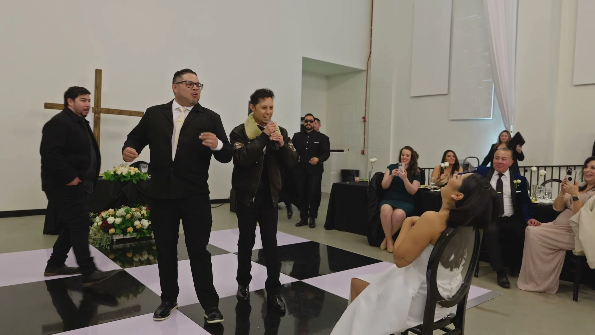 Groomsmen dancing for Sabrina on the checkered floor