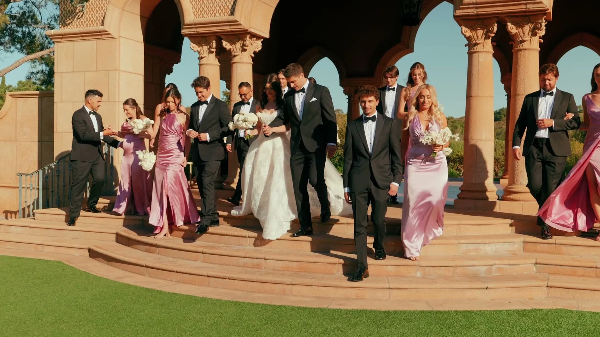 The wedding party on the terrace steps outside the chapel