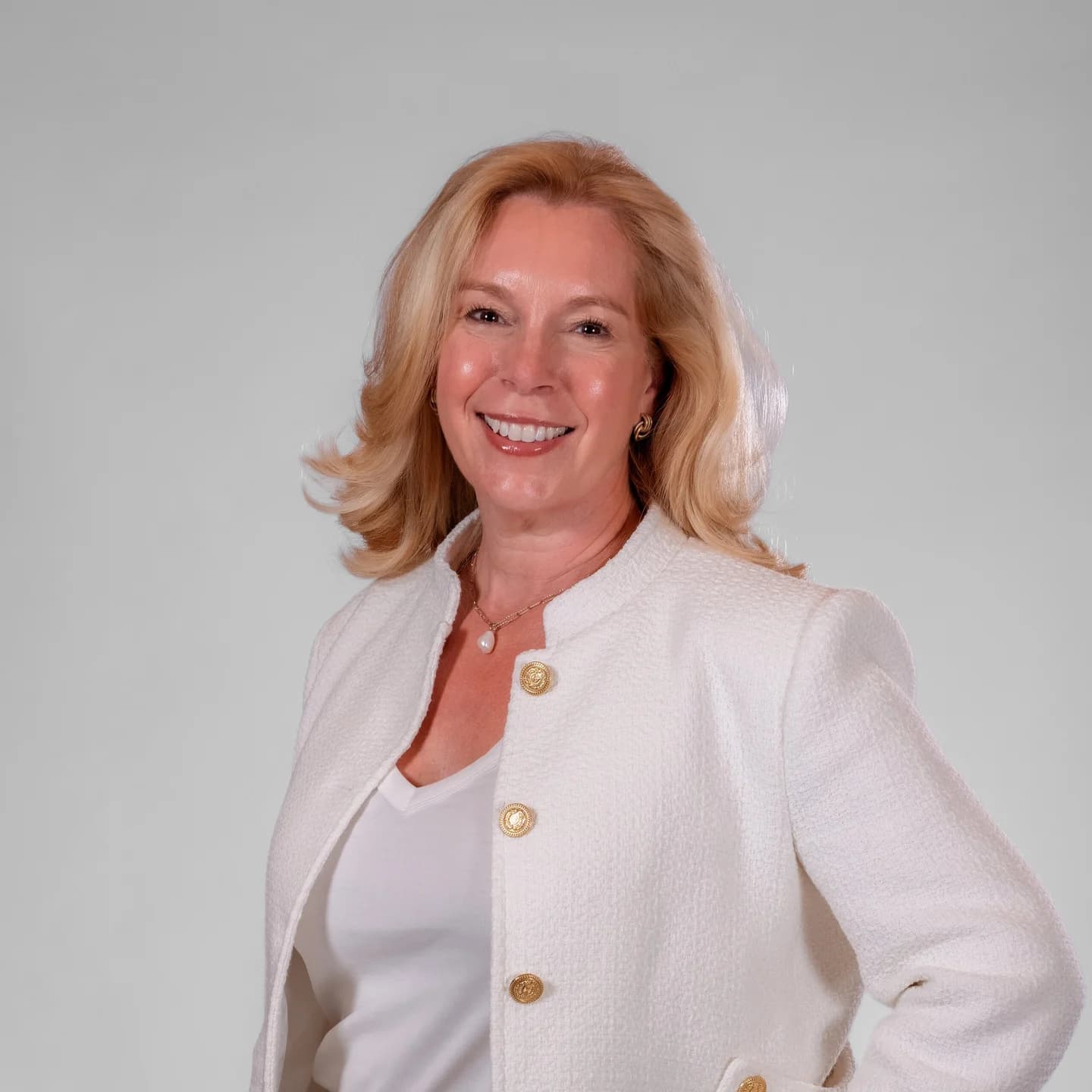 Studio headshot of a conference speaker in a white jacket, taken at the on-site headshot station at Adored Wife Weekend, San Diego
